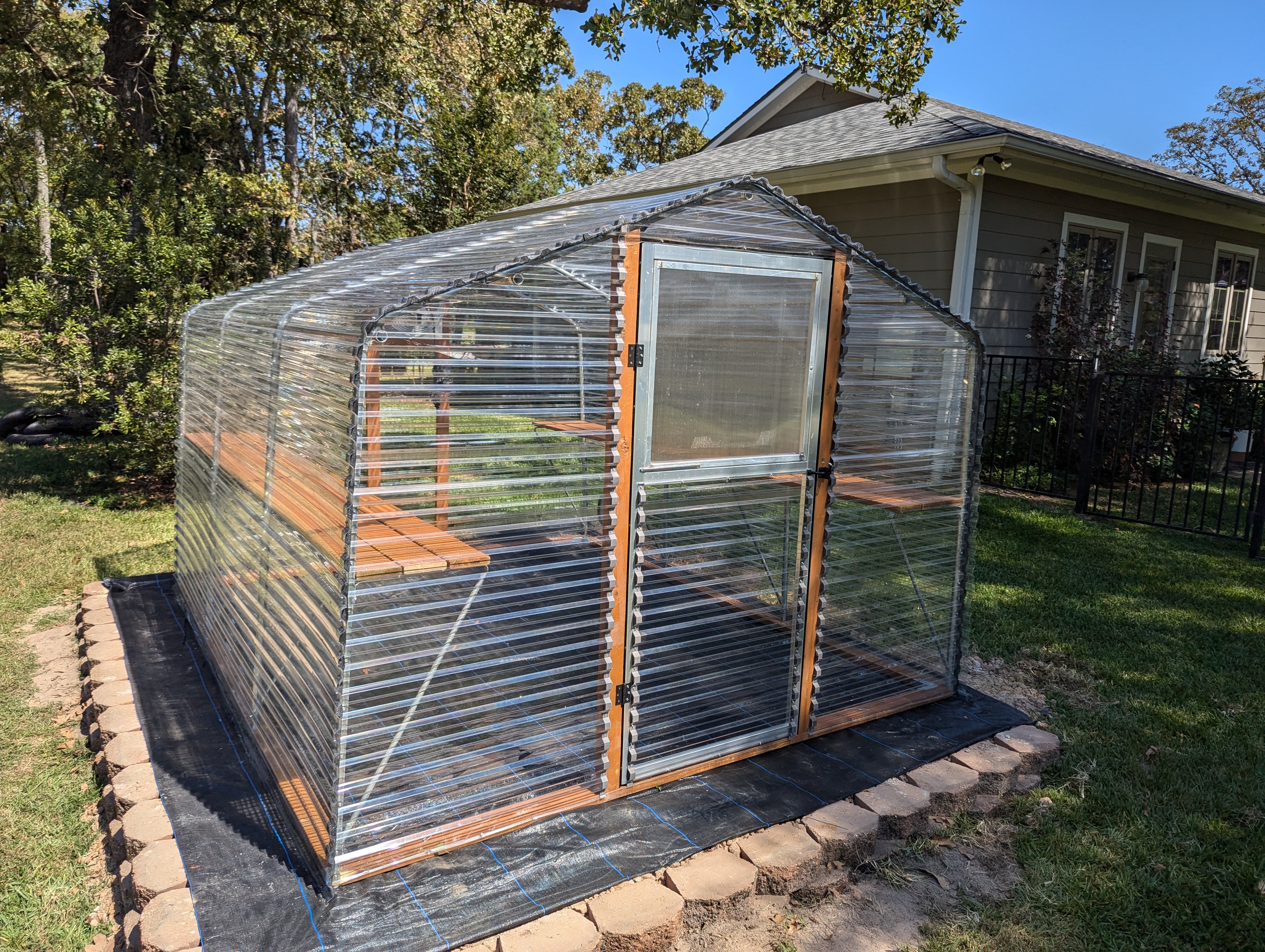 Etexgreenhouse | Greenhouse on a dirt slab inside retainer